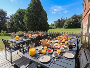 a table with food and drinks on a deck at La Dépendance du Château in Huy