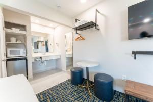 a living room with a table and a counter at The Grove at Pismo Beach in Pismo Beach +19 photos