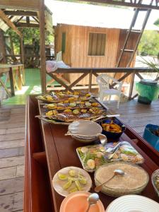 a buffet with many plates of food on a table at Praia Grande Ecolodge in Manacapuru