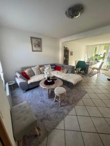 a living room with a couch and a table at Roissy CDG, private room 3 in Roissy-en-France