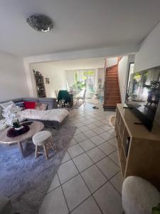 a living room with a couch and a table at Roissy CDG, private room 3 in Roissy-en-France +5 photos