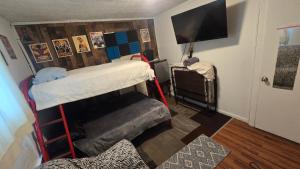 a room with two bunk beds and a flat screen tv at Grateful Hemphill in Atlanta