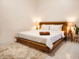 a bedroom with a large bed with white sheets at Villa Monroe - Elegant Private Pool Villa in Ban Nok