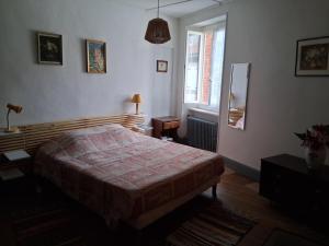 a bedroom with a bed and a window at La maison du Thoré in Saint-Amans-Valtoret