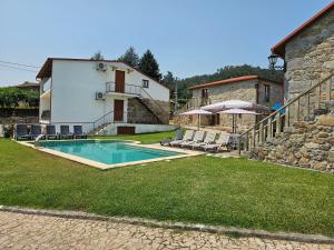 a house with a swimming pool in a yard at Quinta da Cachada in Lousada