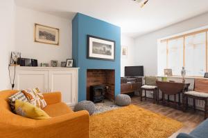 a living room with a couch and a fireplace at JACKS COTTAGE - Cosy Cottage in the Heart of Richmond in Richmond