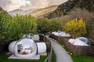 a row of domes in a field with trees at Burbujas a las puertas de Andorra in Argolell
