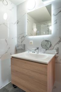 a bathroom with a sink and a mirror at Hotel Bryghia in Bruges +30 photos
