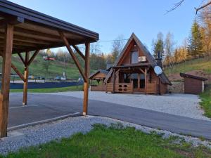 a large wooden cabin with a roof on a road at Vikendica IVA in Pale