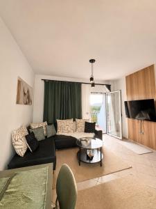 a living room with a couch and a table at Zen Stay Maisonette in Igoumenitsa