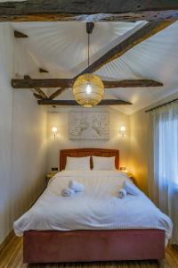 a bedroom with a large bed with towels on it at Silk House in Souflíon