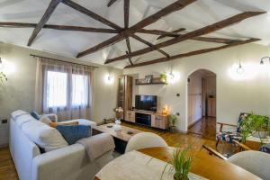 a living room with a couch and a table at Silk House in Souflíon +20 photos