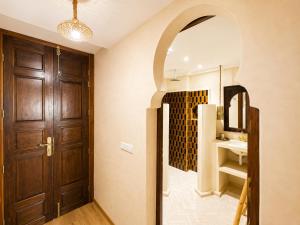 a hallway with a door and a bathroom with a sink at Wave chaser surfhouse morocco in Agadir +70 photos