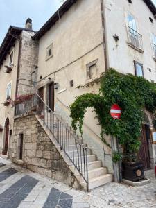 a building with a staircase in front of a building at La Finestra Sul Paese in Pescocostanzo