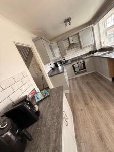 a large kitchen with white cabinets and a counter at Ellington Escape in Ellington +13 photos