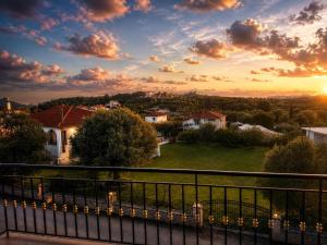 a view of a sunset from a balcony of a house at Zen Stay Maisonette in Igoumenitsa