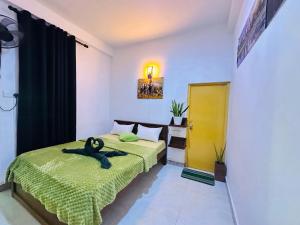 a bedroom with two beds and a yellow door at Jaya Villa - Near Airport in Negombo +112 photos