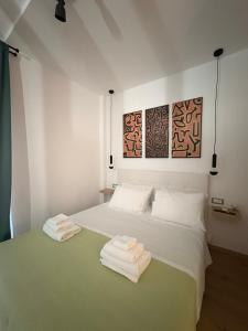 a bedroom with a bed with towels on it at Zen Stay Maisonette in Igoumenitsa +16 photos