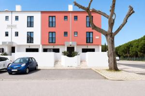 a car parked in a parking lot in front of a building at Mouraliz Apartments by HD PROPERTIES - Vilamoura Marina in Vilamoura