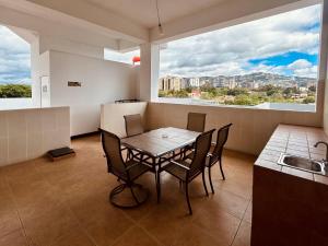 a dining room with a table and chairs in a kitchen at Suites Jardín Imperial in Guatemala