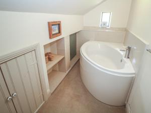a bathroom with a white tub and a sink at Green Farm Stables in Ashbourne +25 photos