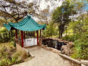 a gazebo with a fountain in a park at Suites Jardín Imperial in Guatemala