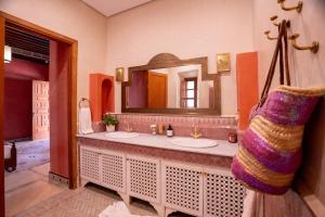 a bathroom with two sinks and a mirror at Daba Village in Marrakesh +94 photos