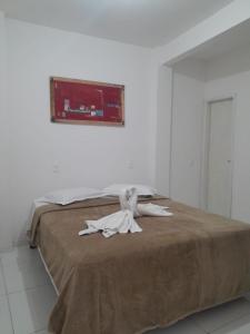 a bed with a towel on top of it at Casa Verde in Morro de São Paulo