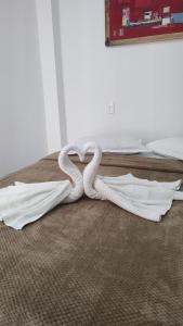 a white snake laying on the floor of a bedroom at Casa Verde in Morro de São Paulo