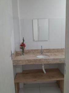 a bathroom with a sink and a mirror at Casa Verde in Morro de São Paulo