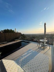 a balcony with a pool and a table and a tableearcher at Nidos de carnota in San Mamede de Carnota