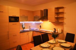a kitchen with a table with chairs and a sink at Guest House SAM-WATER in Đenovići +31 photos