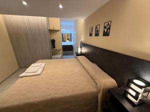 a bedroom with a bed with two towels on it at Hotel El Paraiso Boutique in Villa Carlos Paz +176 photos