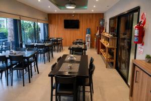 a dining room with tables and chairs in a restaurant at Hotel El Paraiso Boutique in Villa Carlos Paz