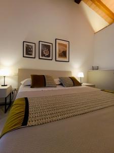 a bedroom with two beds and two lamps on the wall at Su Cappeddu Agriturismo in San Giorgio