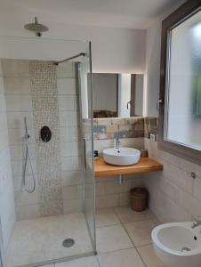 a bathroom with a sink and a shower at Su Cappeddu Agriturismo in San Giorgio