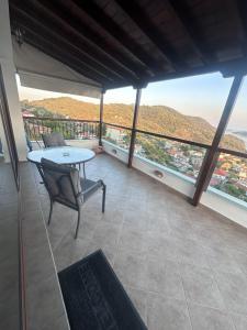 a balcony with a table and a view of the city at Casa Gaia - Unit 1 in Glossa +16 photos