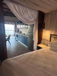 a kitchen and a bedroom with a bed and a table at Casa Gaia - Unit 1 in Glossa