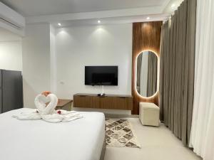 a hotel room with a bed with a swan decoration on it at Florenza Khamsin Resort in Hurghada