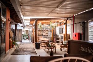 a restaurant with a table and chairs in a room at Serra Negra Pousada Spa - by Easy Hotéis in Guarapari