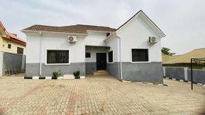 a white house with a driveway in front of it at LaCasa Abuja in Abuja