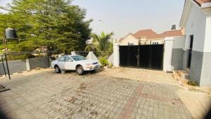 a car parked in a driveway in front of a house at LaCasa Abuja in Abuja +3 photos