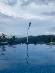 a swimming pool with a light on top of it at Habitaciones cama doble in La Vega