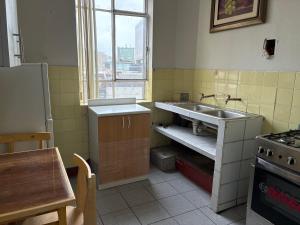 a kitchen with a sink and a table in it at Nazareth in Lima
