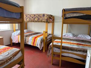 a room with three bunk beds and a window at Nazareth in Lima