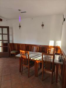 a dining room with a table and wooden chairs at Beli oblaki in Gradišče v Slovenskih Goricah