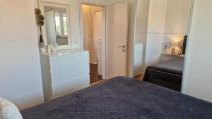 a bedroom with a bed and a dresser and a mirror at Apartment Vanessa in Murine