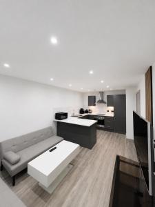 a living room with a couch and a kitchen at AS Residences in Preston