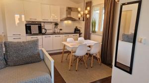 a kitchen and living room with a table and chairs at Apartment Vanessa in Murine