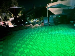 a green floor with chairs and umbrellas on a patio at Cabana Mea STRAJA in Lupeni